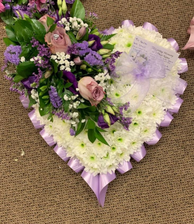 Funeral Heart - White Massed Heart with a lilac & purple Spray and a lilac ribbon edge. A beautiful arrangement to send to a funeral.