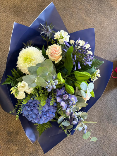 Blue beauty - Stunning handtied of blue and cream flowers.

Content may vary