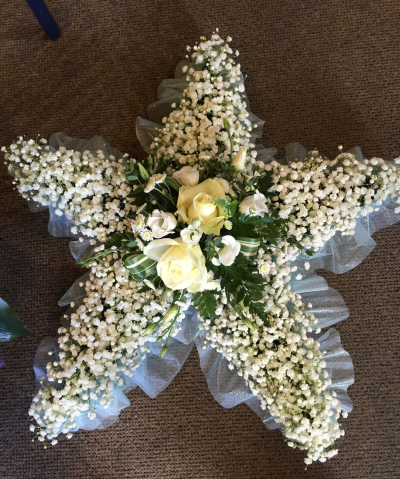 Star - Star shaped funeral tribute based in gyp with a white spray